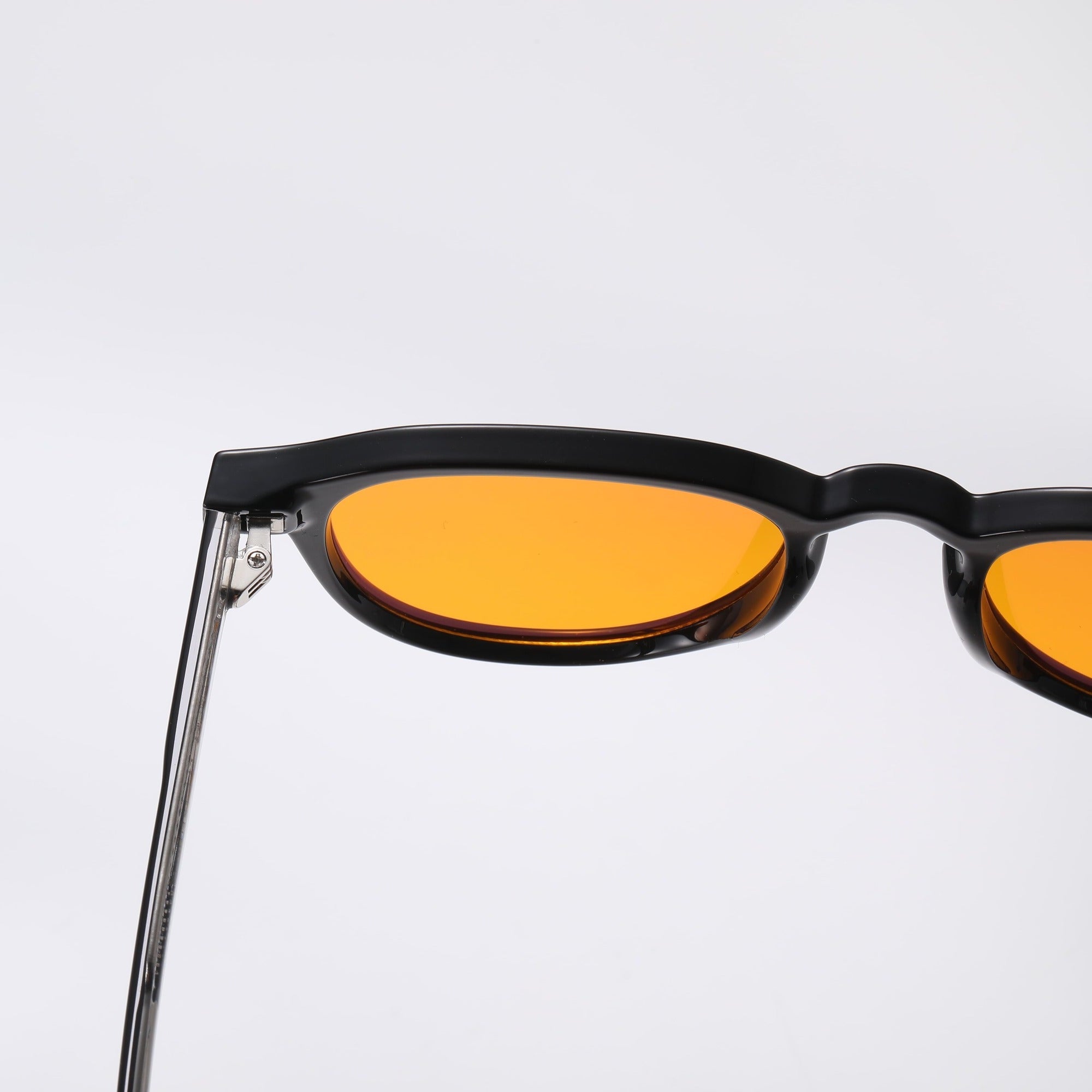 Black square-framed sunglasses with orange lenses on a white background.