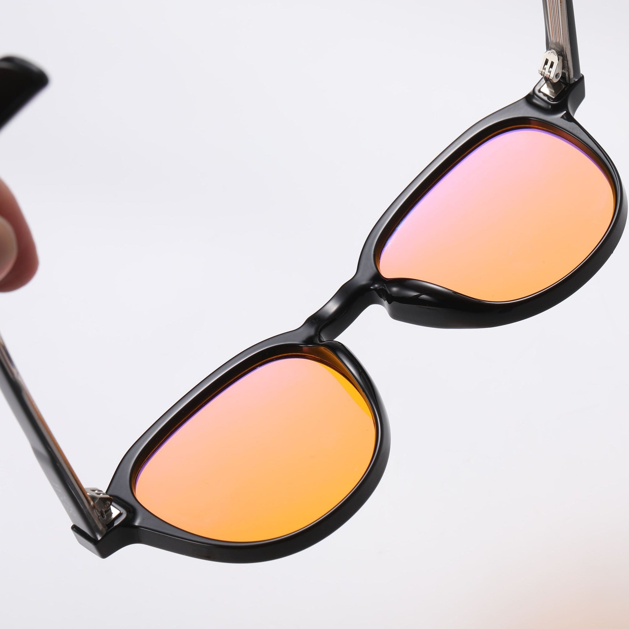 Black square-framed sunglasses with orange lenses on a white background.
